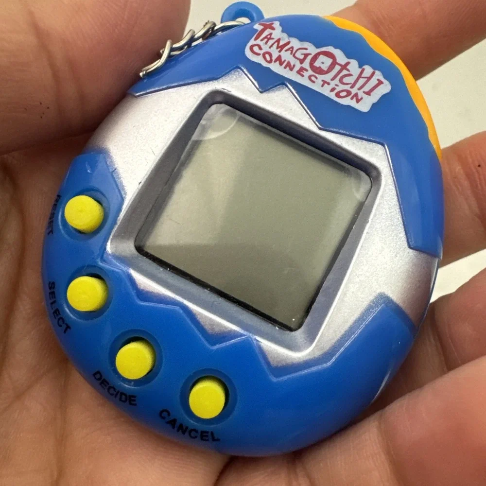 2 Collectors Tamagotchi With Crack On Plastic On Right Side Still Works